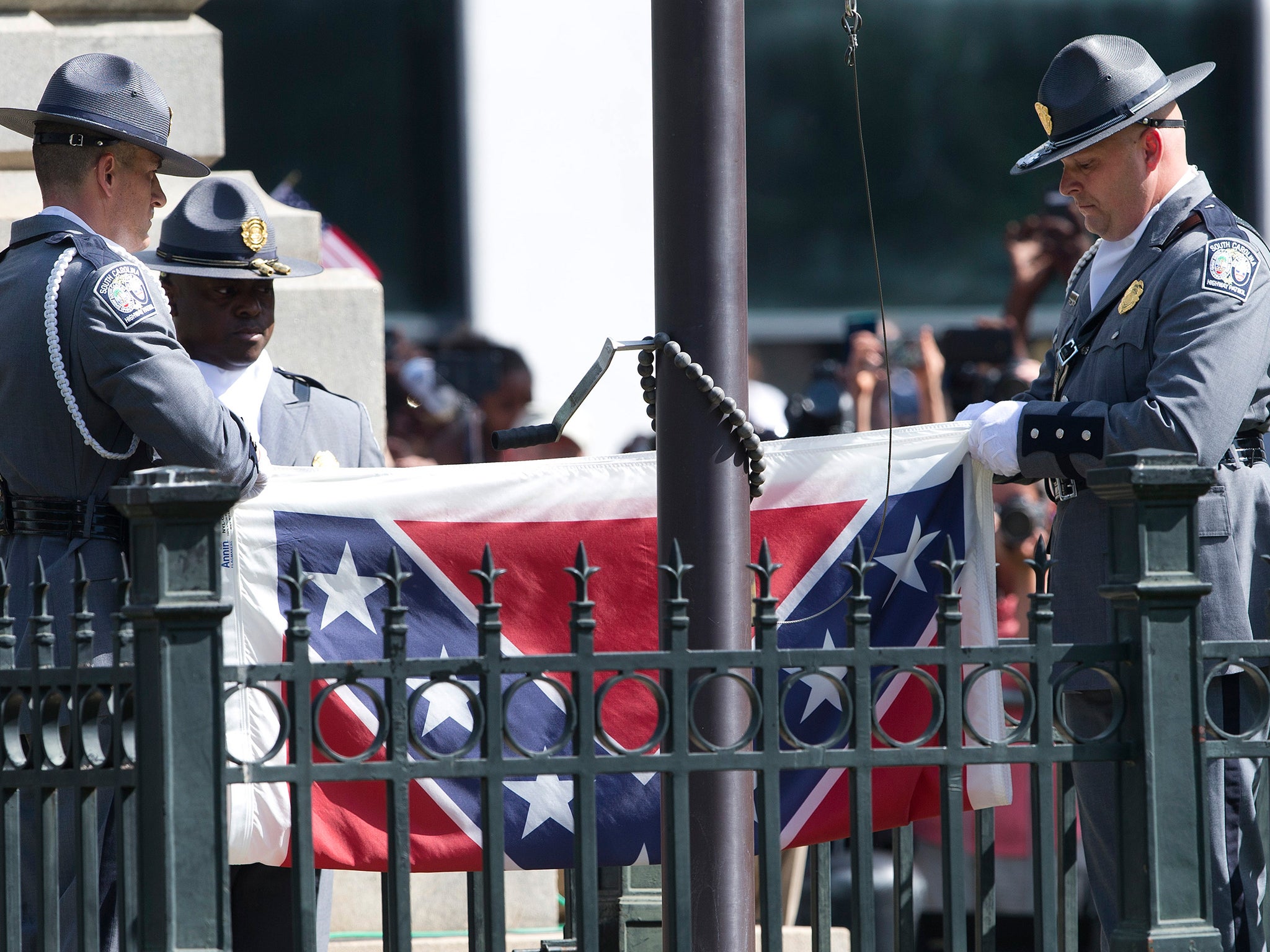 An honor guard from the South Carolina Highway patrol removes the Confederate battle flag from the Capitol grounds in Columbia