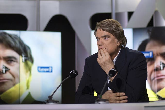 Embattled tycoon Bernard Tapie attends a broadcasted debate on French news channel iTele