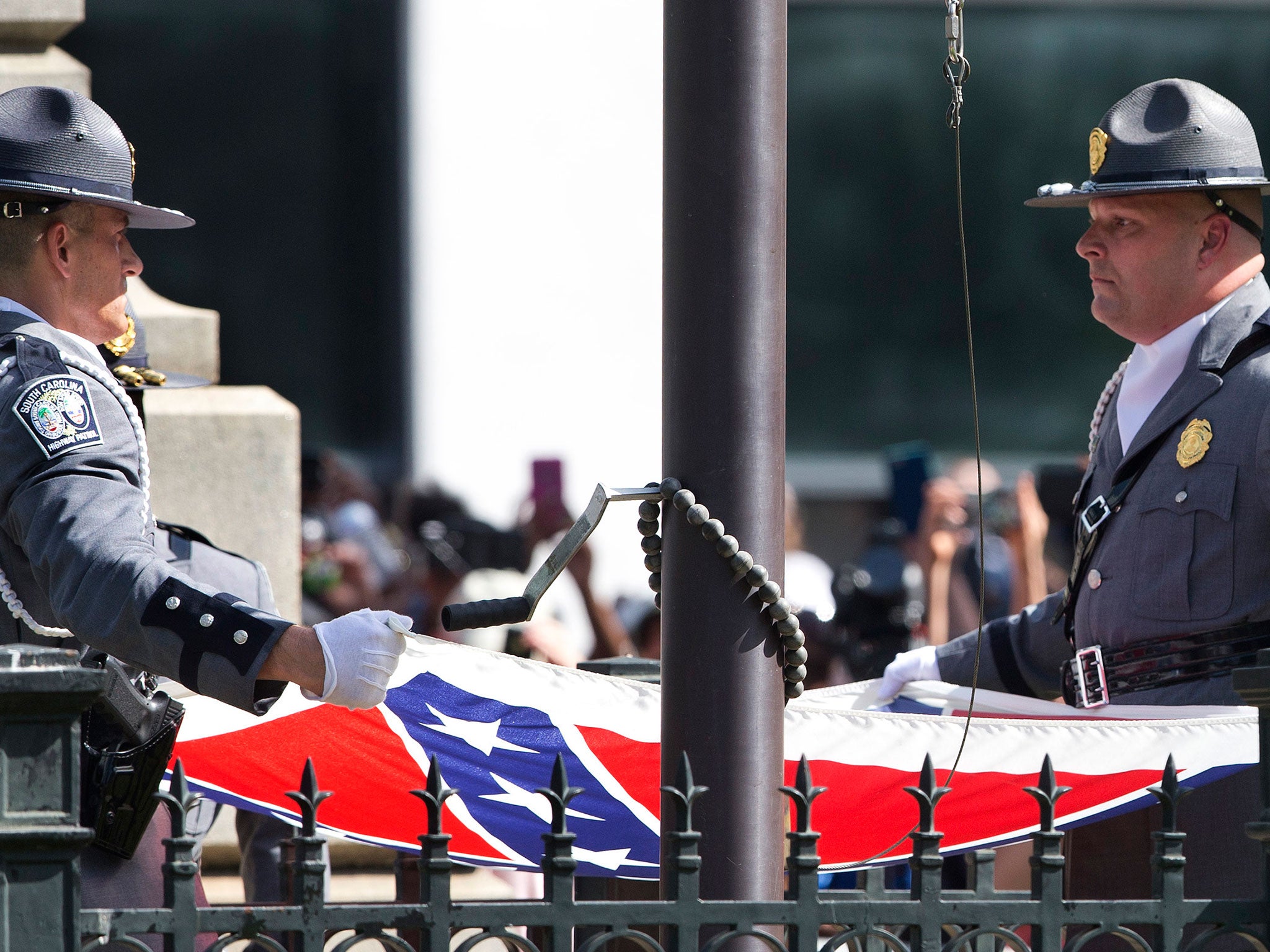 An honor guard from the South Carolina Highway patrol removes the Confederate battle flag from the Capitol grounds in Columbia, S.C.