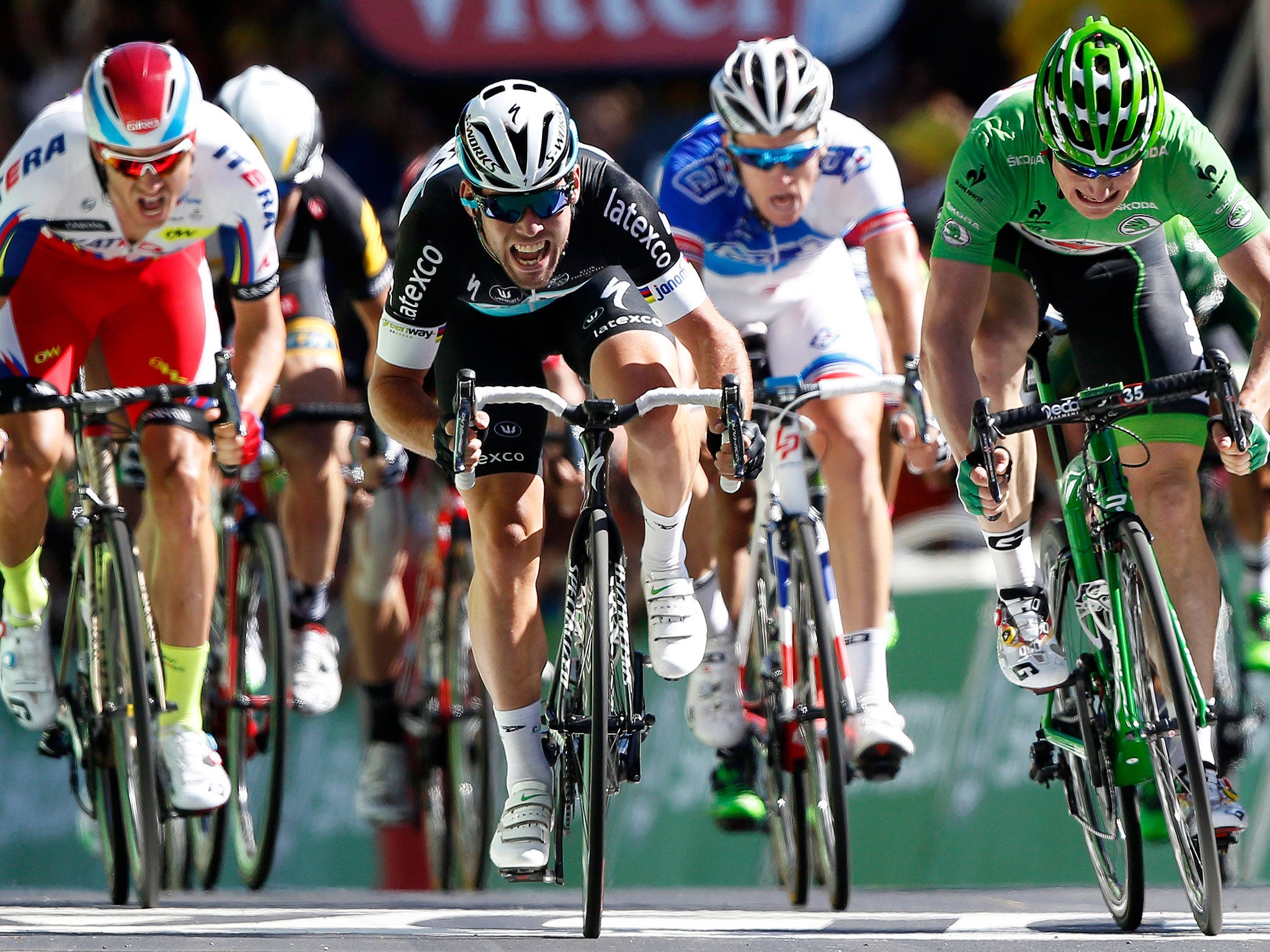 Mark Cavendish (centre) surges to a sensational stage victory in Fougères yesterday