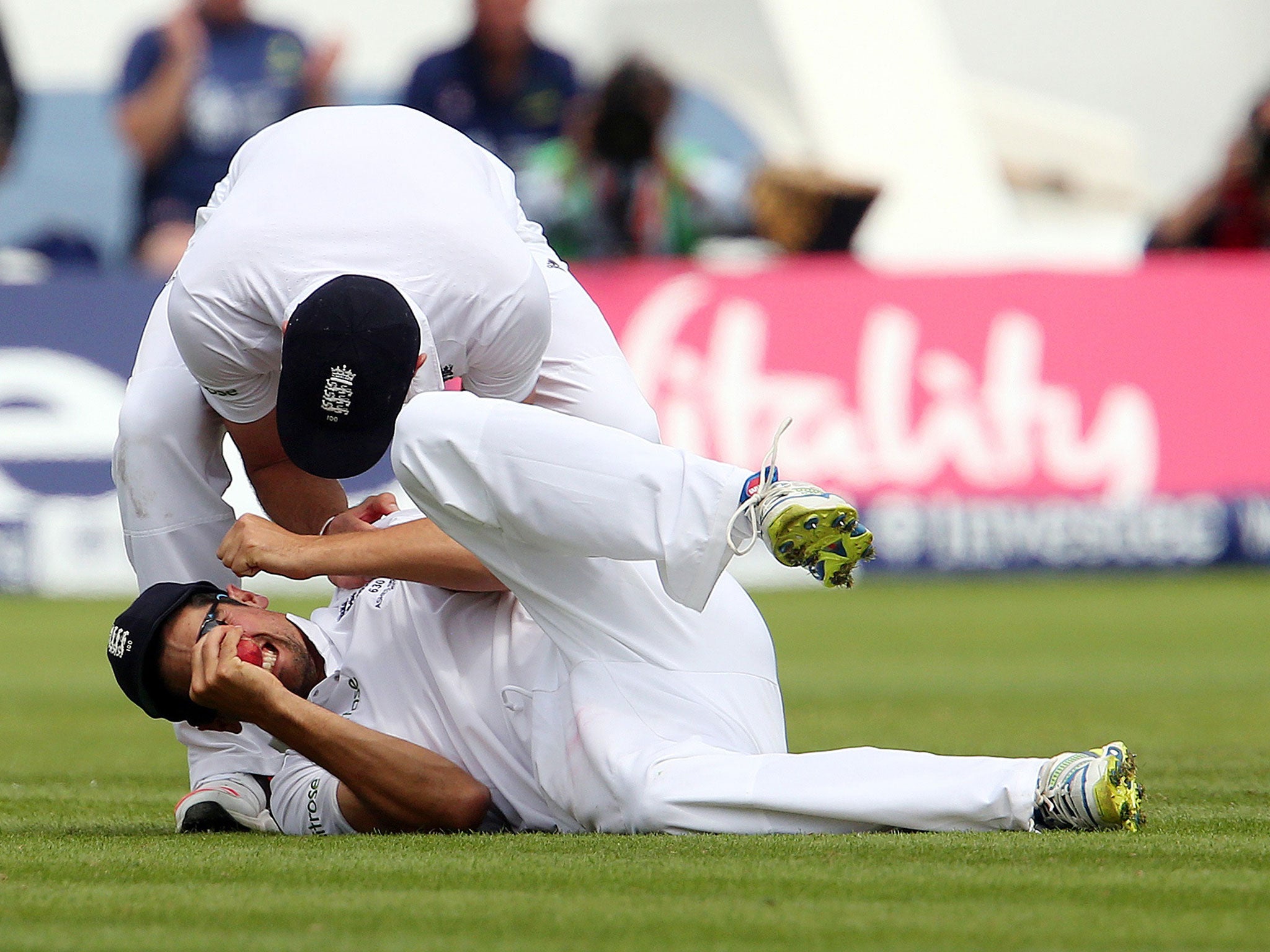 Cook celebrates taking a brilliant catch to dismiss Haddin