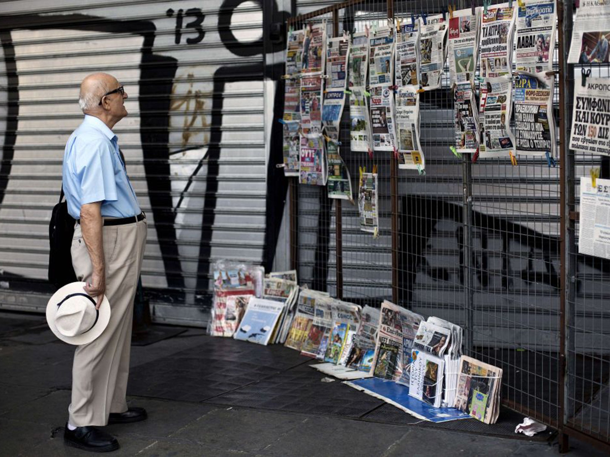 A man reads the headlines in Athens on Saturday