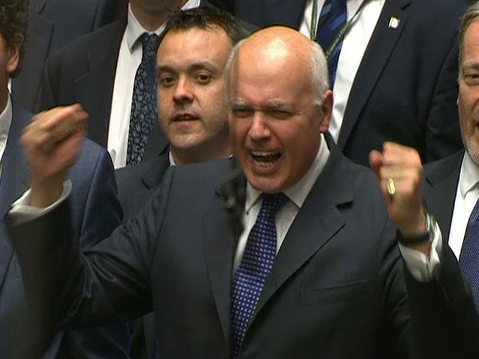 Works and Pensions Secretary Iain Duncan Smith punches the air as he listens to Chancellor of the Exchequer George Osborne deliver his Budget statement to the House of Commons, London.