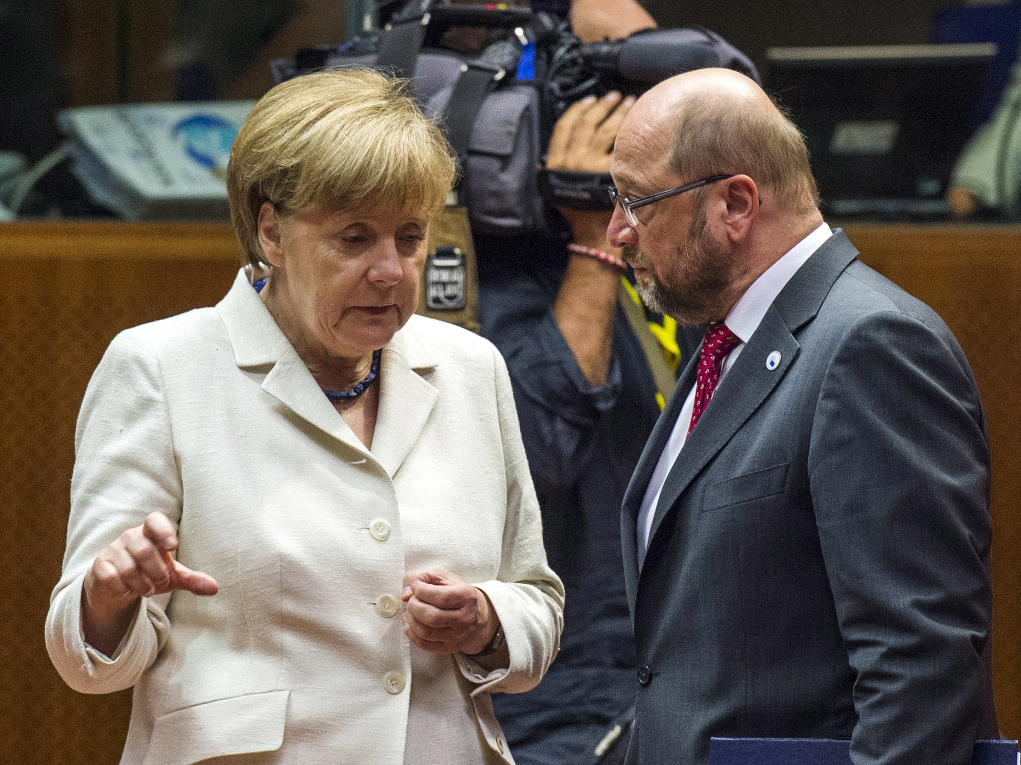 German Chancellor Angela Merkel, left, confers with European Parliament President Martin Schulz