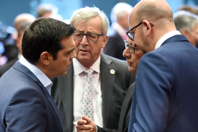 Greek Prime Minister Alexis Tsipras, left, speaks with, from left, European Commission President Jean-Claude Juncker, French President Francois Hollande and Belgian Prime Minister Charles Michel during a meeting of eurozone heads of state at the EU Counci