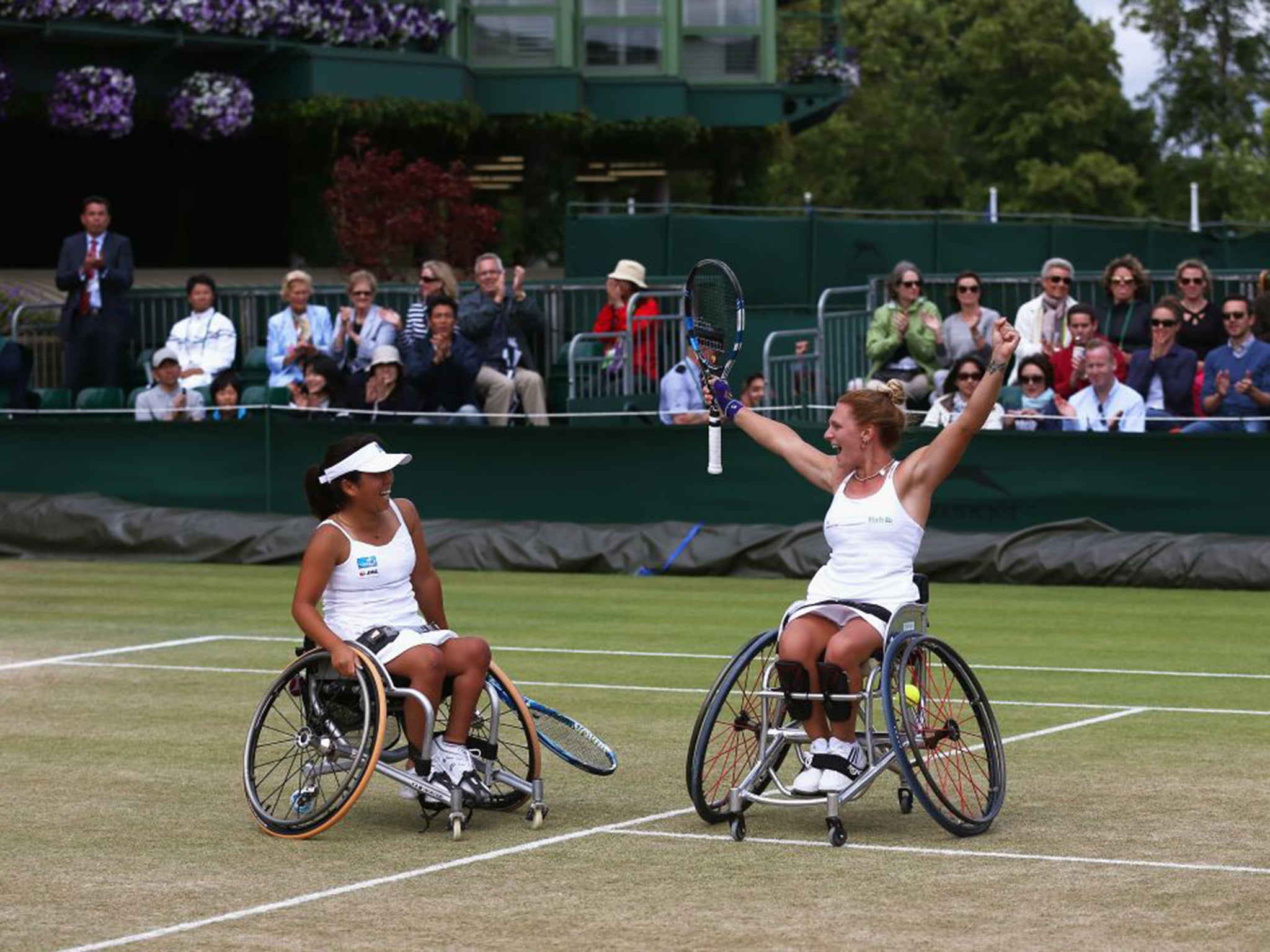 Great Britain’s Jordanne Whiley, right, celebrates retaining the women’s wheelchair doubles title with Yui Kamiji, of Japan