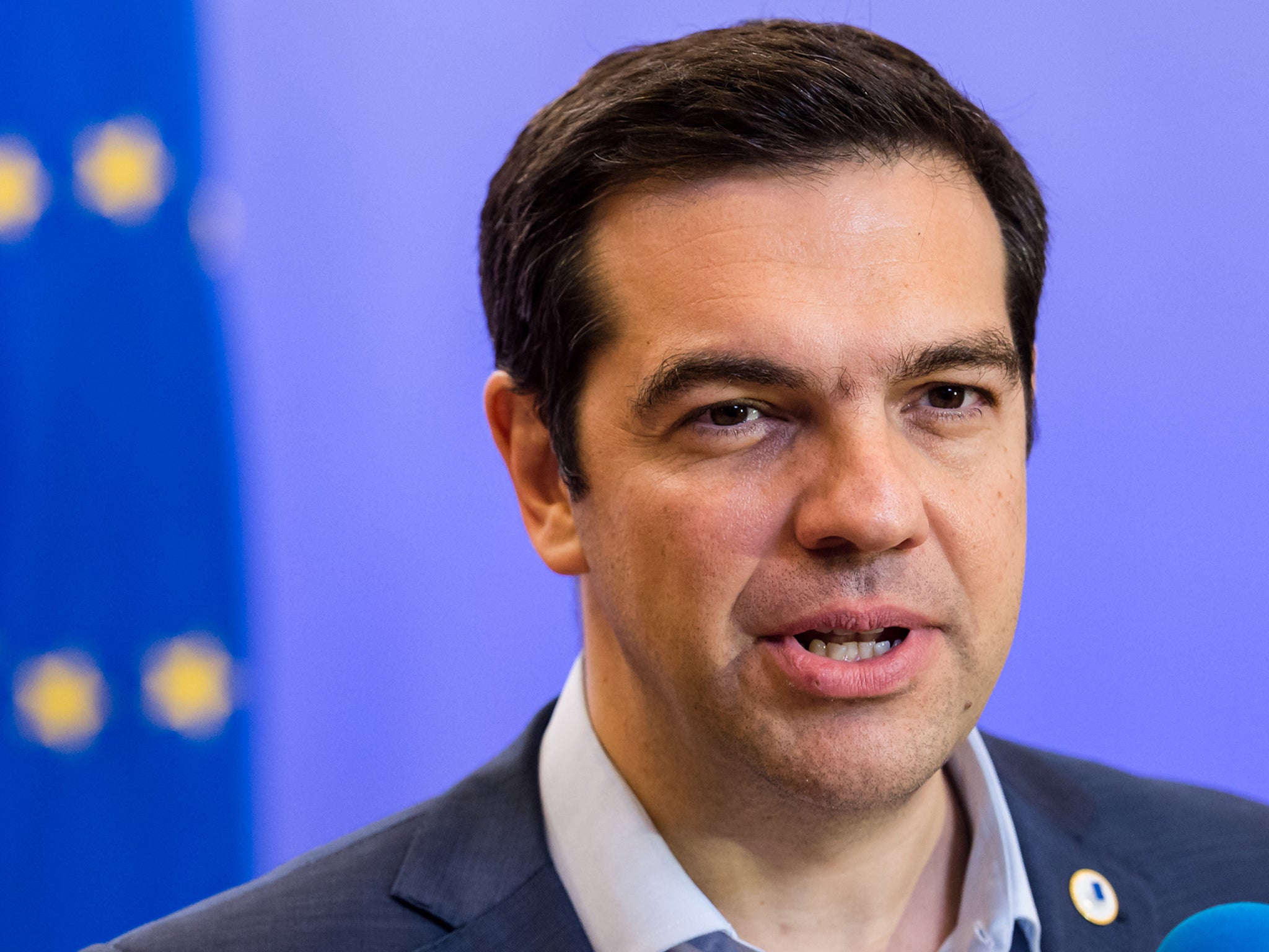 Alexis Tsipras speaks with the media after a meeting of eurozone heads of state at the EU Council building in Brussels