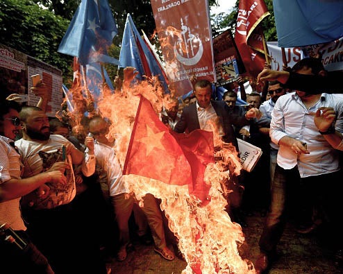 Turkish nationalist protesters in Ankara, Turkey burning the Chinese flag