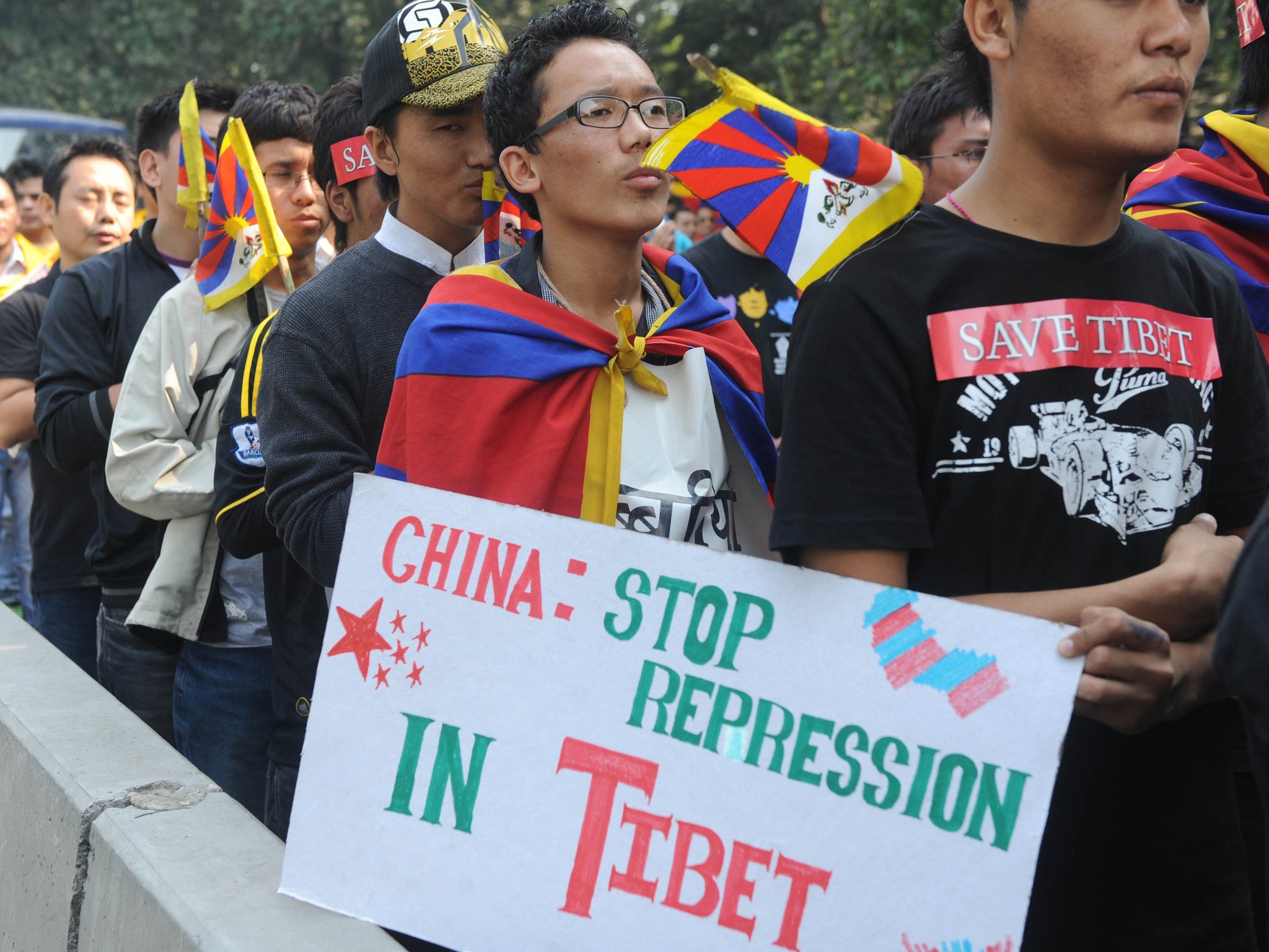 Tibetan protesters march during a Tibetan people's solidarity movement rally near the Chinese embassy in New Delhi on November 16, 2011. Around 500 Tibetans marched close to the Chinese embassy to denounce Chinese rule in Tibet. In China, at least five monks and two nuns have died in a wave of self-immolation protests, rights groups say, with the most recent death being reported a week ago when a nun set fire to herself in Sichuan province. AFP PHOTO/ RAVEENDRAN