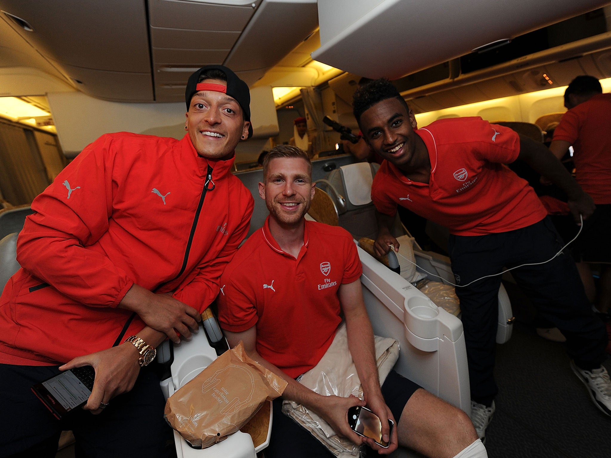 Mesut Ozil, Per Mertesacker and Gedion Zelalem on the plane