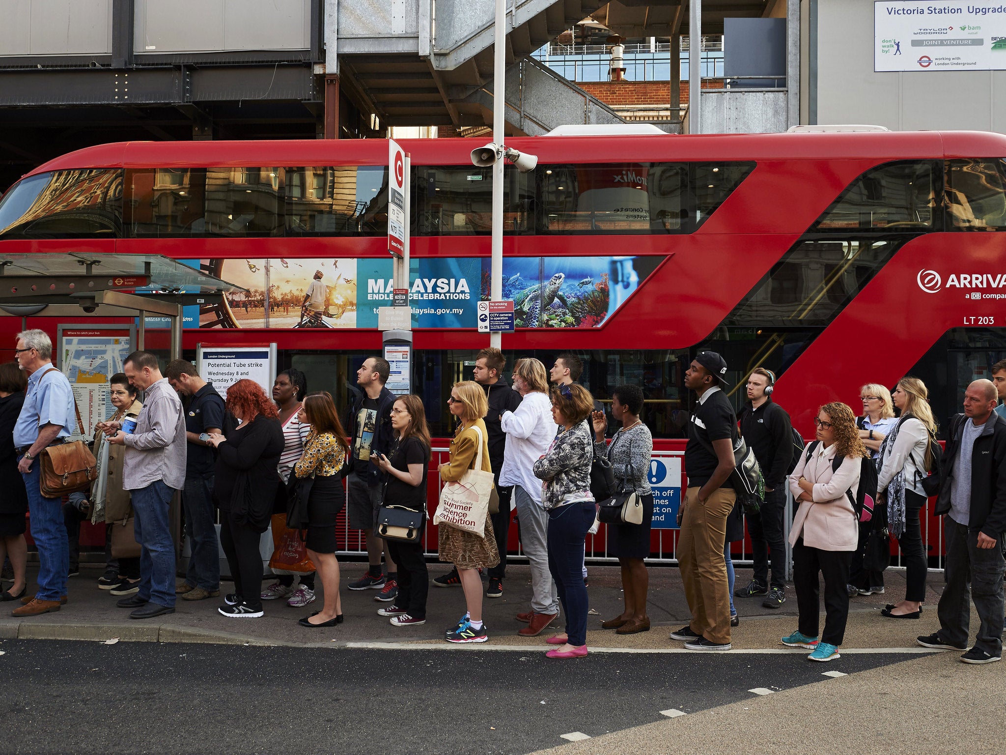 Londoners queue for a bus during a massive tube strike on 9 July