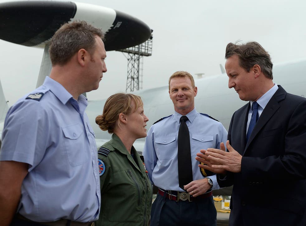 David Cameron with Flight Lieutenant Sarah Vamplew at RAF Coningsby in Lincolnshire. The Prime Minister faces a Commons vote on easing the fox-hunting ban
