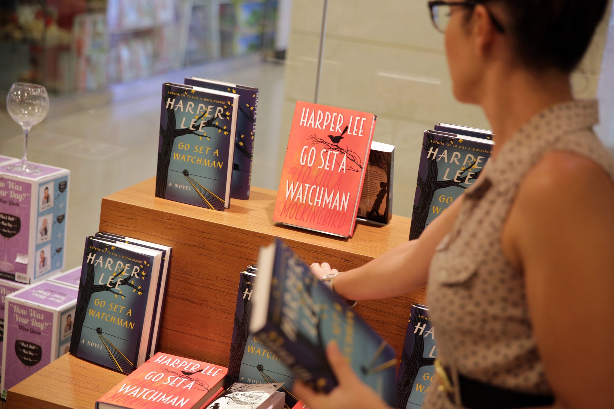 A bookseller displays copies of Go Set A Watchman before the midnight release of Harper Lee's novel