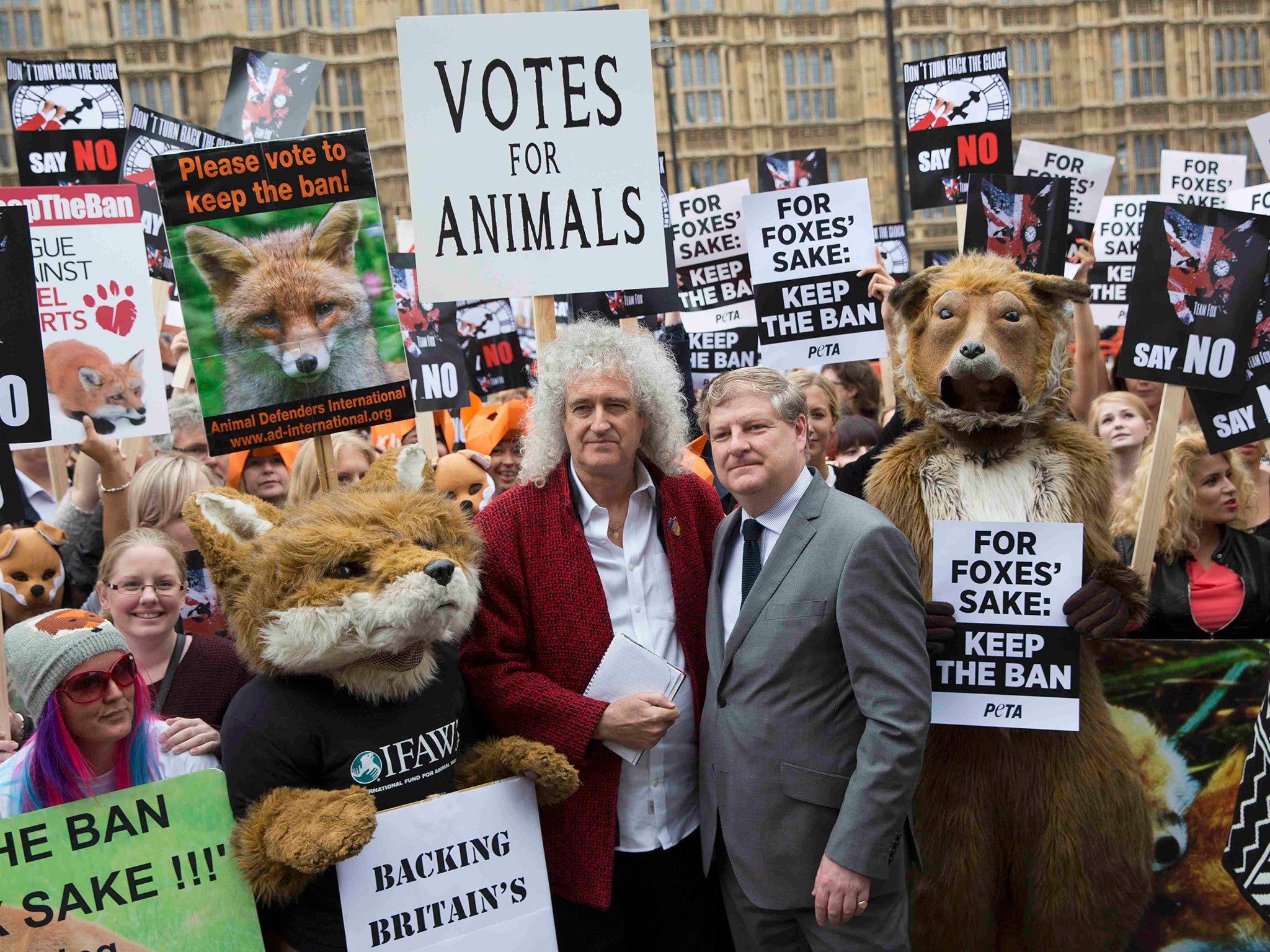 Brian May and Scottish National Party MP Angus Robertson stand with demonstrators