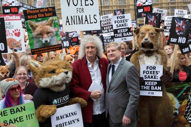 Brian May and Scottish National Party MP Angus Robertson stand with demonstrators 