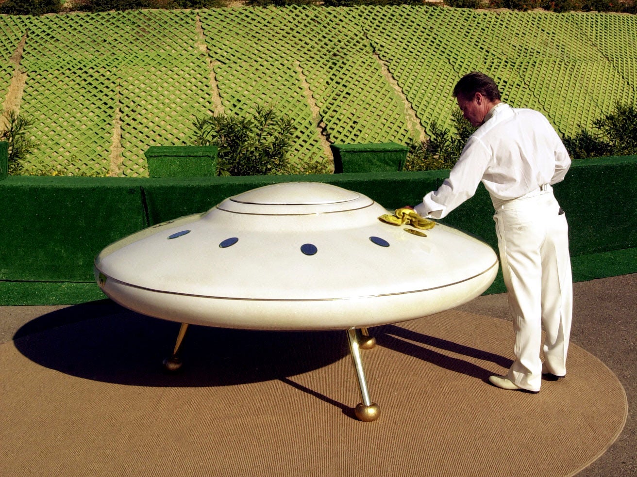 A man polishes his flying saucer in California