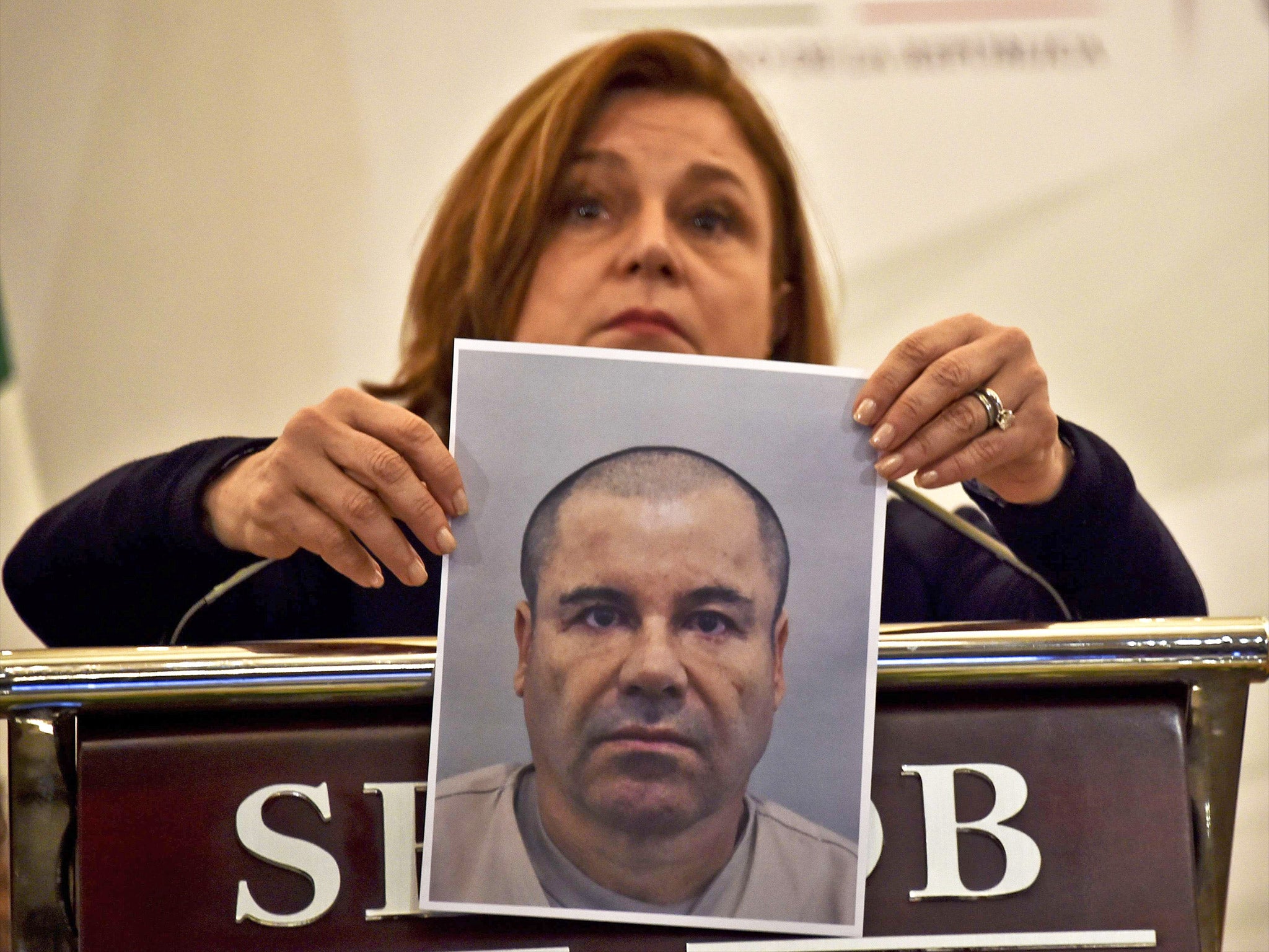 Mexico’s Attorney General Arely Gomez shows the press a picture of Guzman