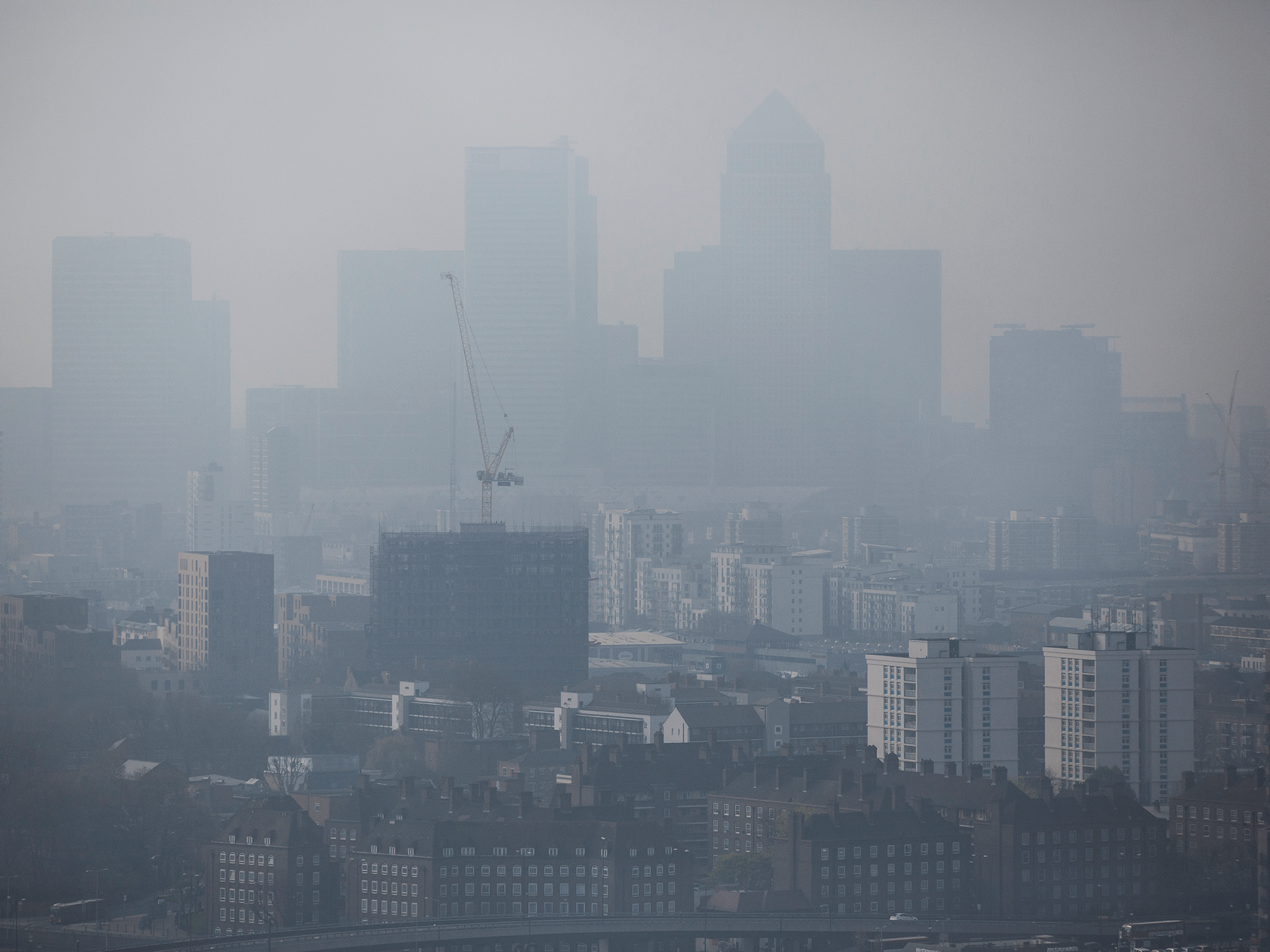 A general view through smog of the Canary Wharf financial district in London on April 2, 2014