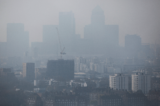 A general view through smog of the Canary Wharf financial district in London on April 2, 2014
