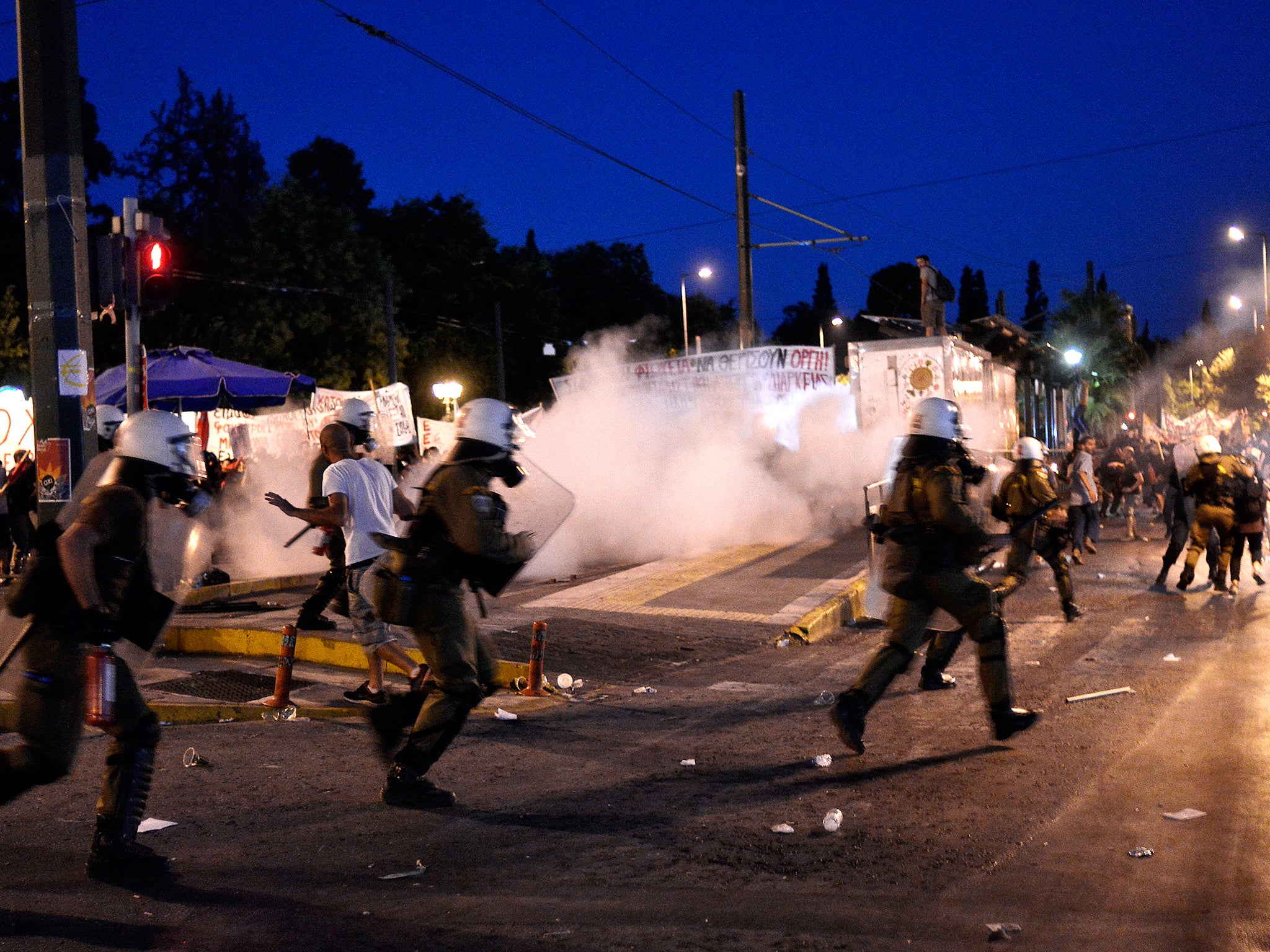 Riot police use teargas in front of the Greek Parliament