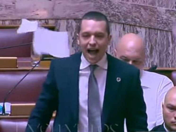 Golden Dawn MP Ilias Kasidiaris tore up the agreement and sent it fluttering over parliament