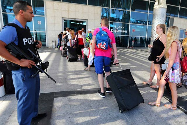 Armed farewell: British tourists leave Tunisia under heavy guard after the Sousse massacre