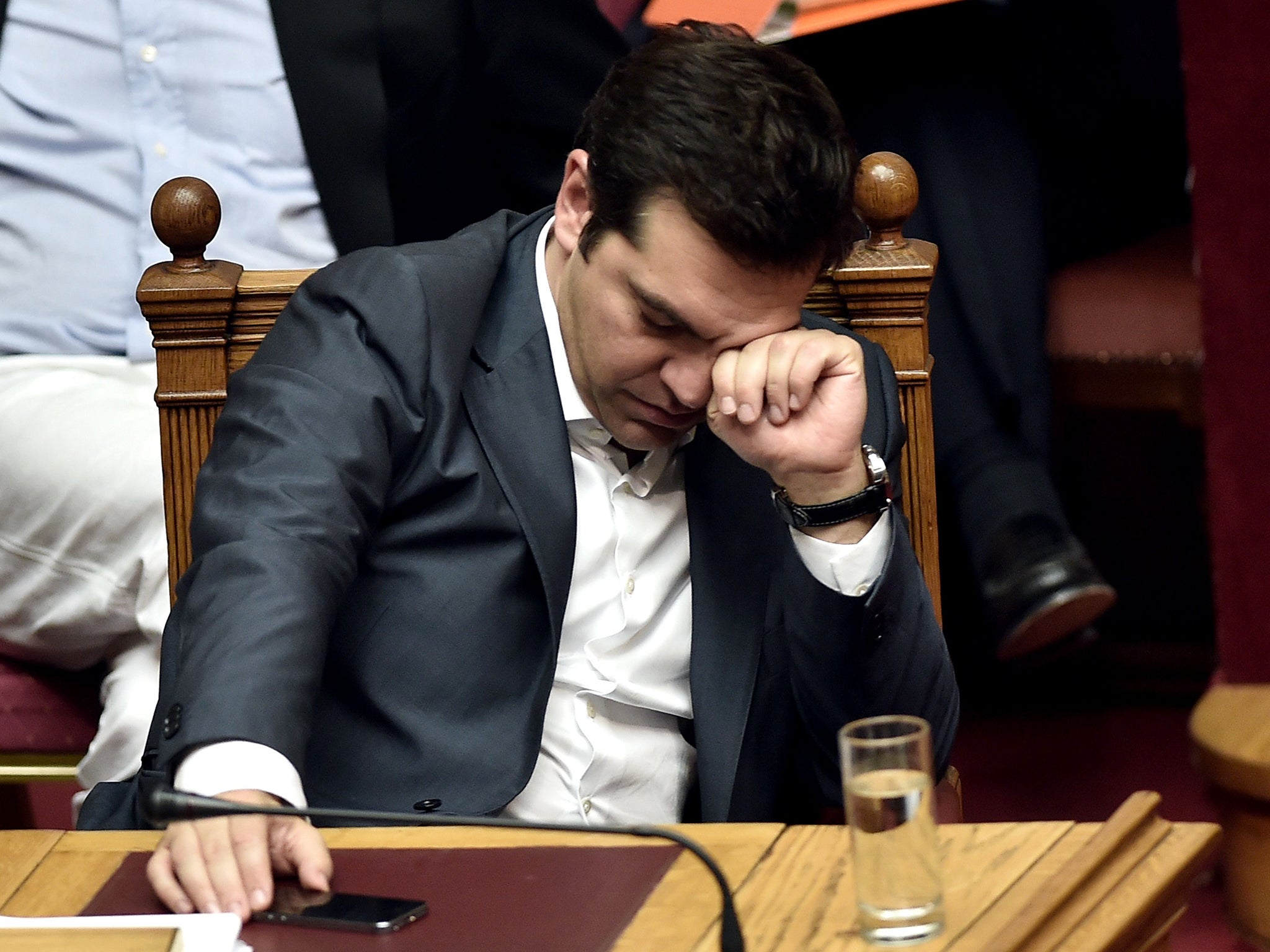 Greek Prime Minister Alexis Tsipras reacts during a parliament session in Athens