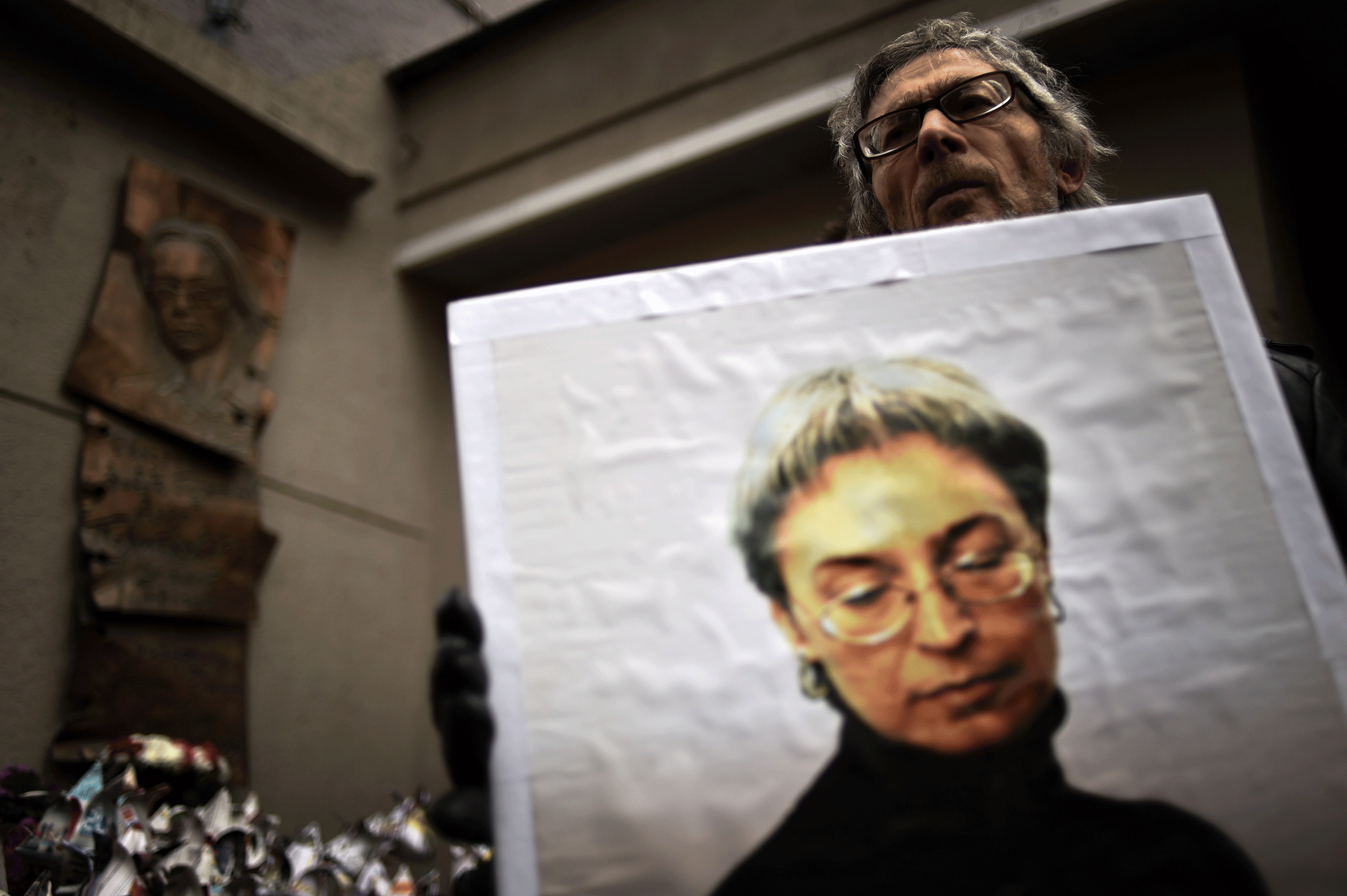 A man holds a portrait of slain Russian journalist Anna Politkovskaya during a rally marking the 8th anniversary of her death in Moscow, last year