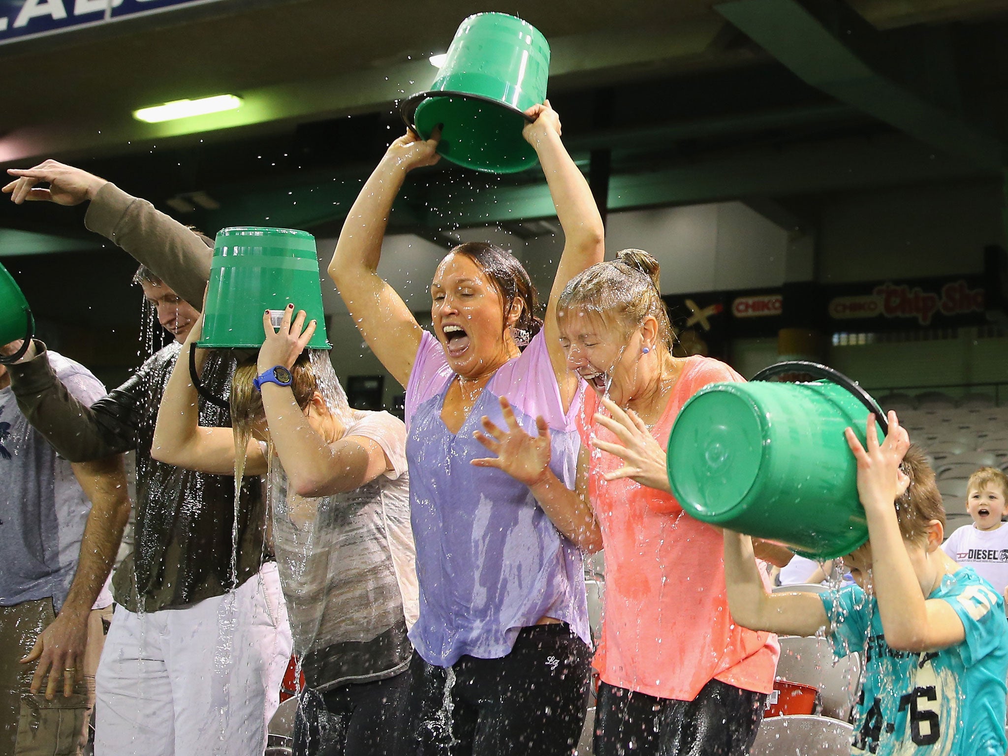 Participants tip buckets of ice water over their heads as they take part in th Ice Bucket Challenge