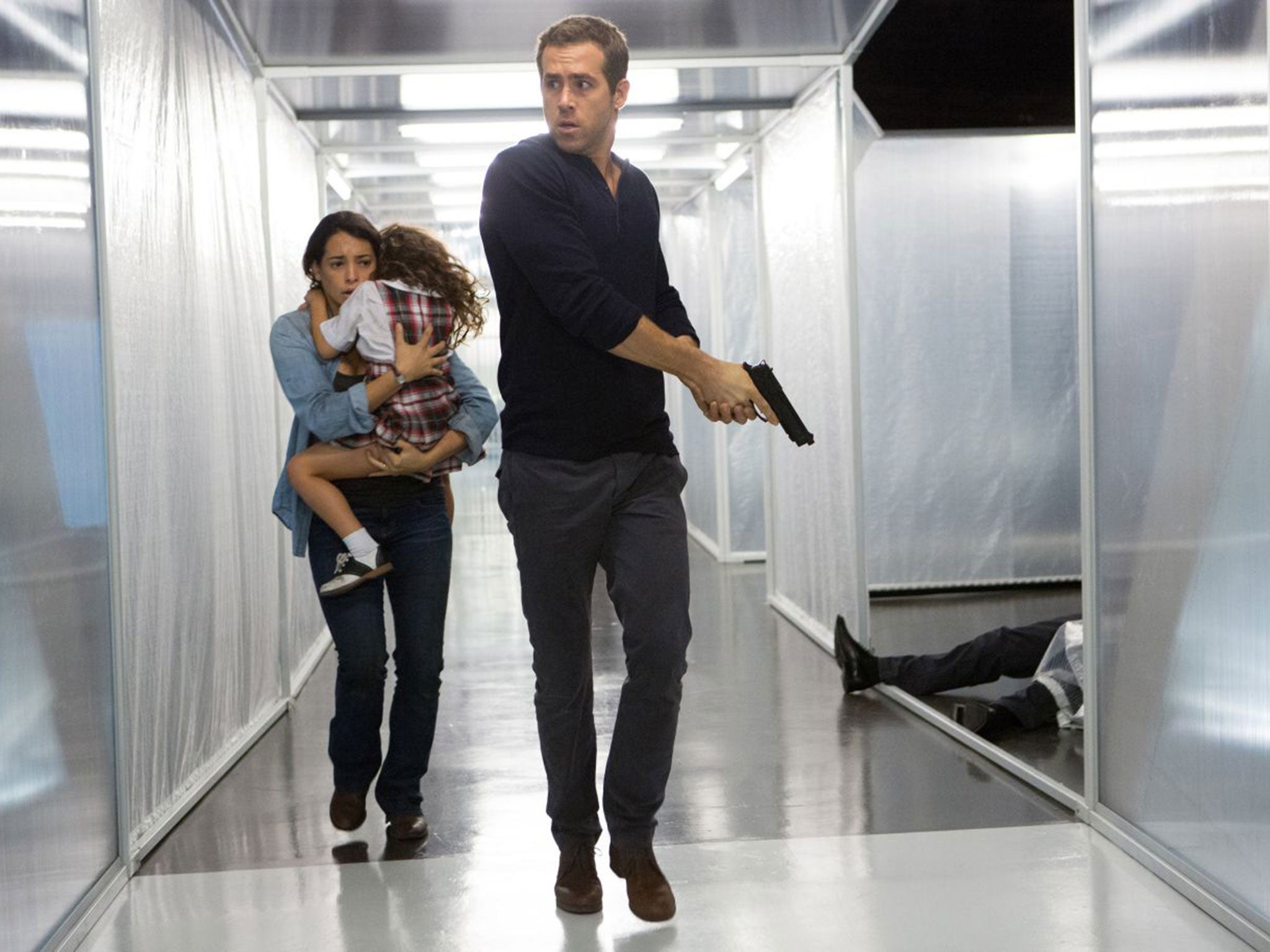 Madeline (Natalie Martinez) and daughter Anna (Jaynee-Lynne Kinchen) flee with Young Damian (Ryan Reynolds) in psychological science fiction thriller Self/less