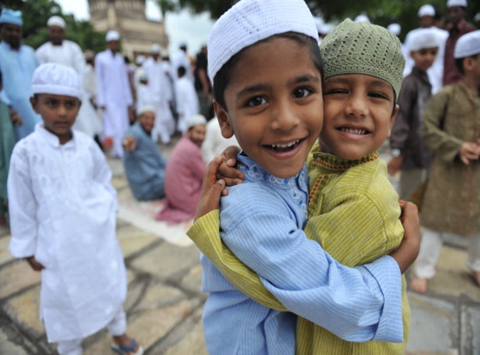 Muslim boys greet one another after Eid prayers at the Qutub Shahi tomb in Hyderabad, India