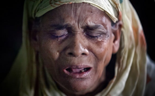 A woman is overcome with emotion as she prays at a mosque in Dhaka, Bangladesh (via Allison Joyce/Getty Images)