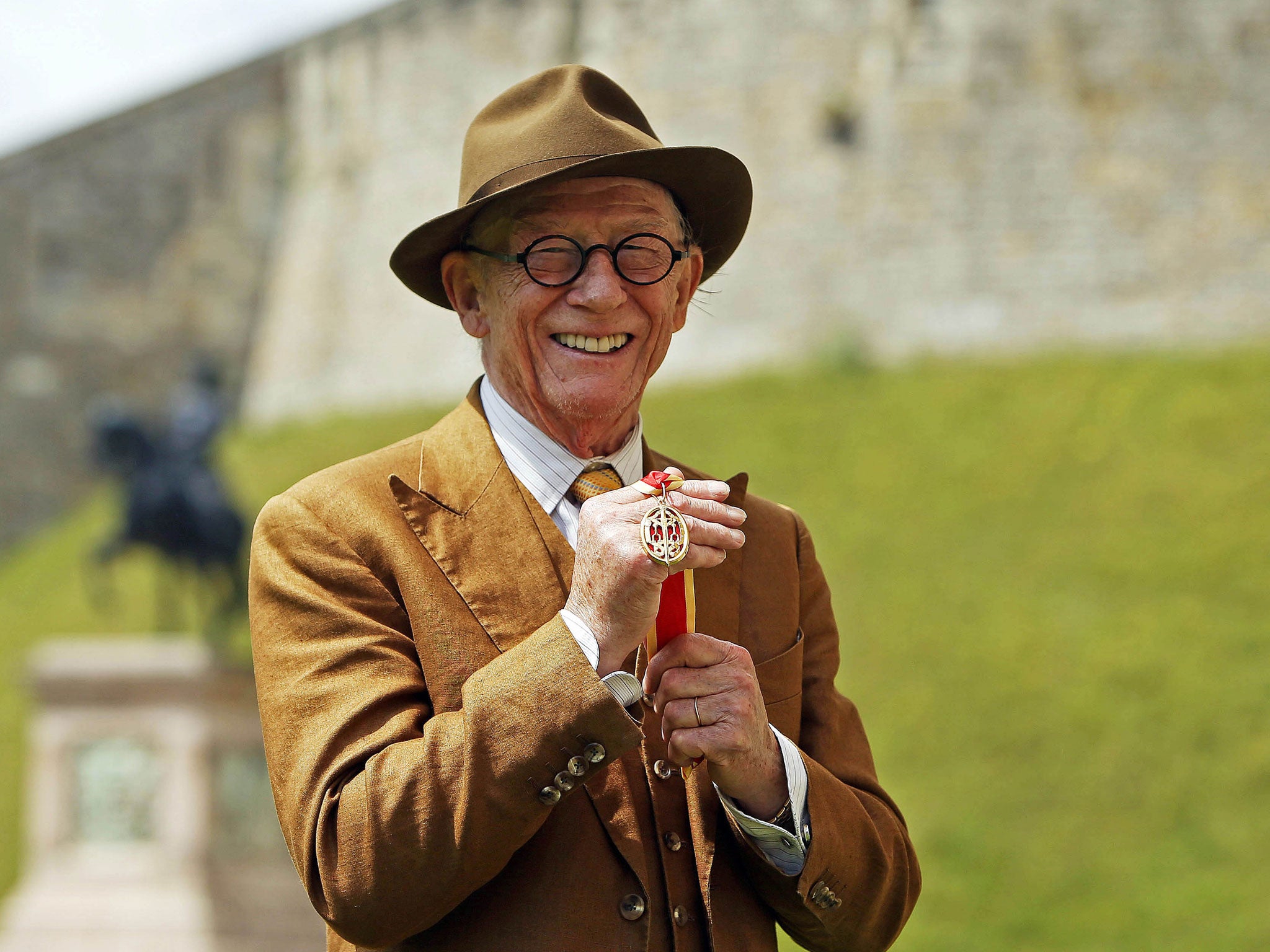 Sir John Hurt after being knighted by the Queen