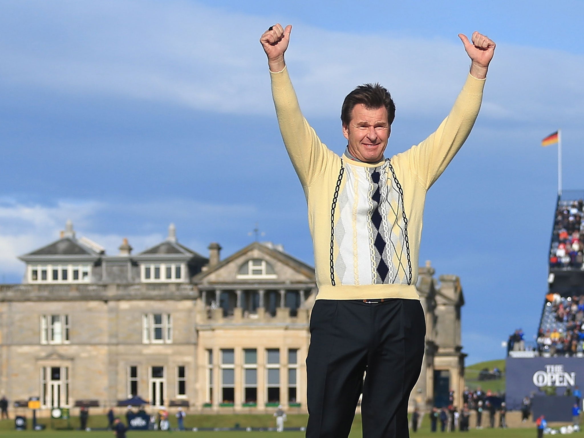 Nick Faldo salutes the crowd as he stands on Swilcan Bridge after his final round at St Andrews