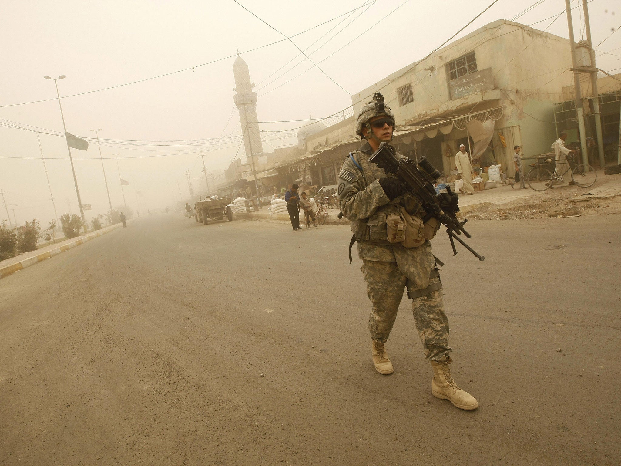 US soldiers and Iraqi police take part in their last joint patrol in Khan Bani Saad, some 10 kms south of the town of Baquba, on June 28 2009, as a sandstorm engulfs this northeastern region of the county. US combat troops will pull out from Iraq's cities