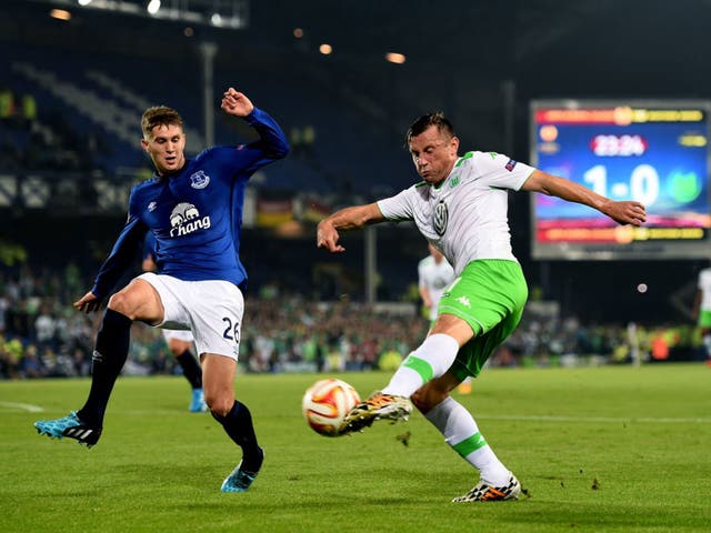Ivica Olic of VfL Wolfsburg crosses the ball as John Stones of Everton closes in during a UEFA Europa League Group H match