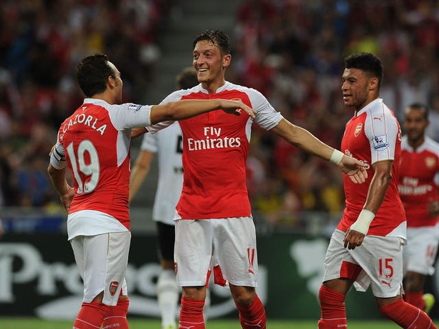 Mesut Ozil celebrates with Santi Cazorla after scoring