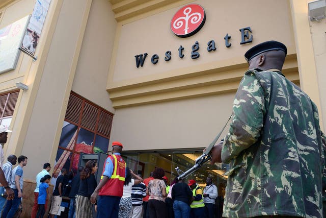 An armed guard outside the shopping centre yesterday, scene of a horrific four-day siege in 2013