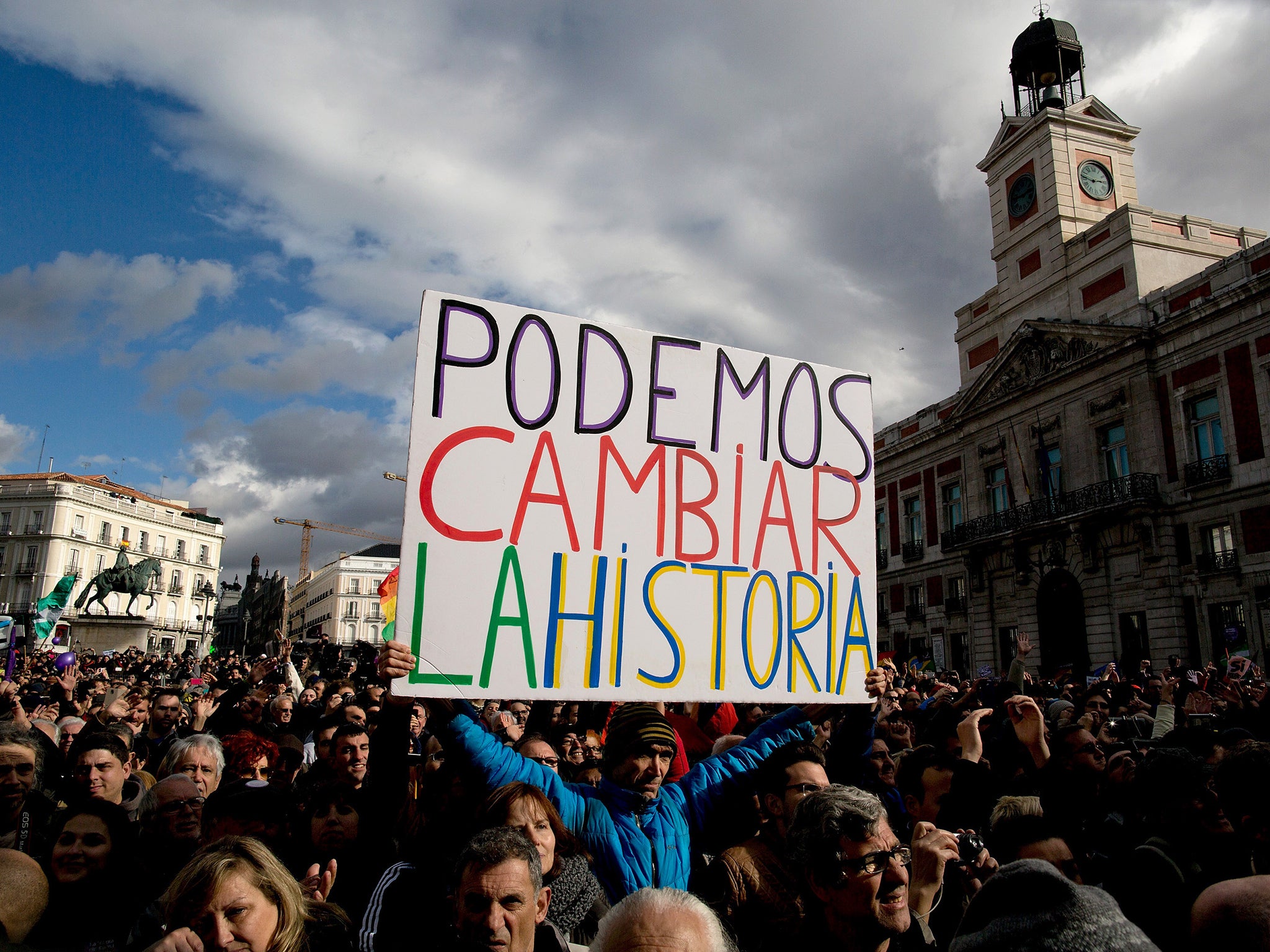 A Podemos party supporter holds a placard reading 'We can change history' at a march in January in Madrid