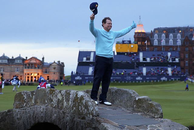 Five-time champion Tom Watson waves a poignant goodbye in the twilight on the Swilcan Bridge