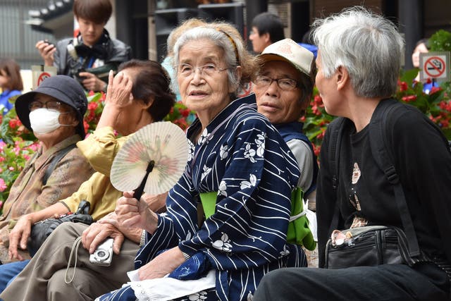 <p>File. Elderly residents rest in the grounds of a temple in Tokyo, Japan </p>