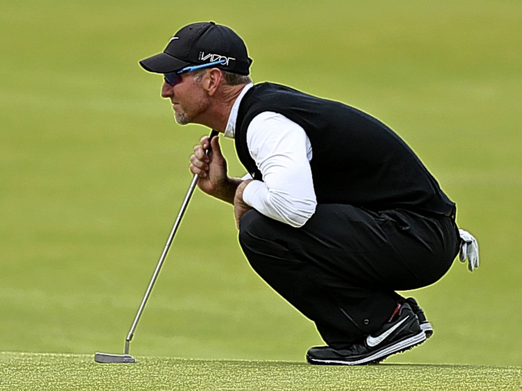 David Duval lines up a putt yesterday during his round of 67