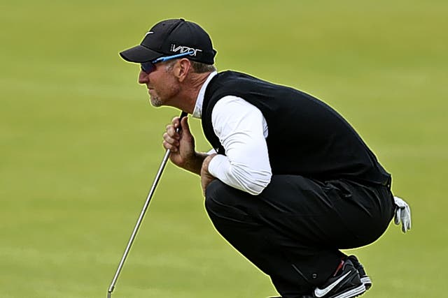 David Duval lines up a putt yesterday during his round of 67 