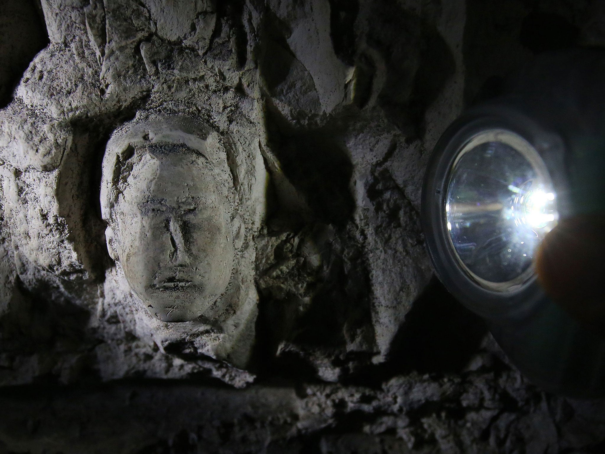 National Trust staff explore the Fan Bay Deep Shelter in Dover where relics and drawings were found