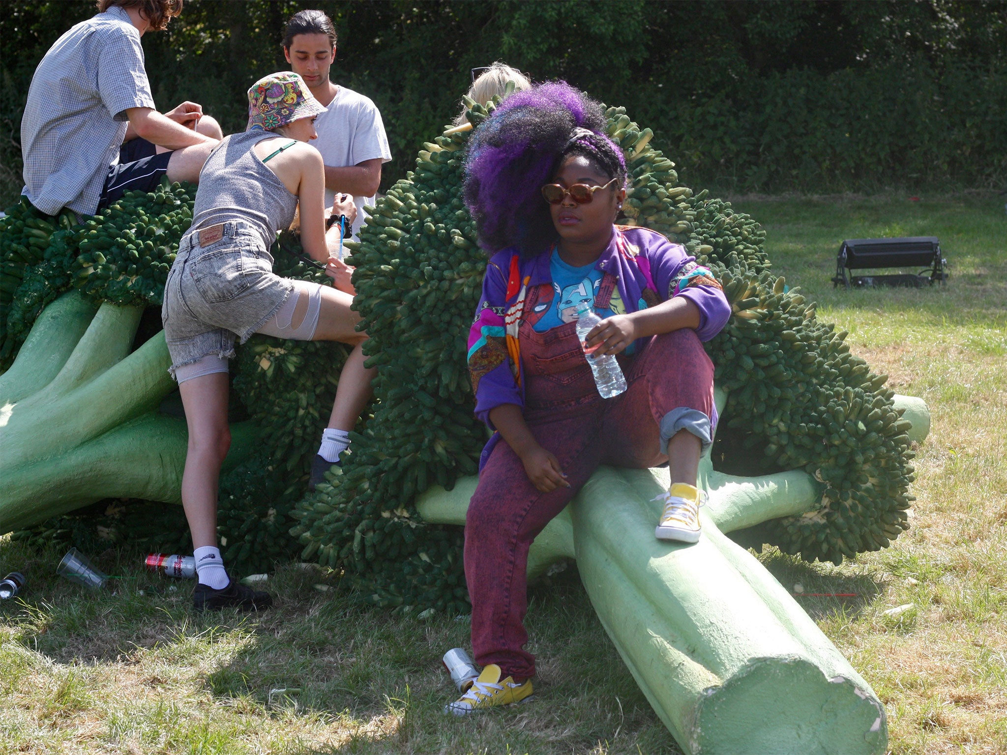 Tank of 'Tank and the Bangas' sits on a giant broccoli