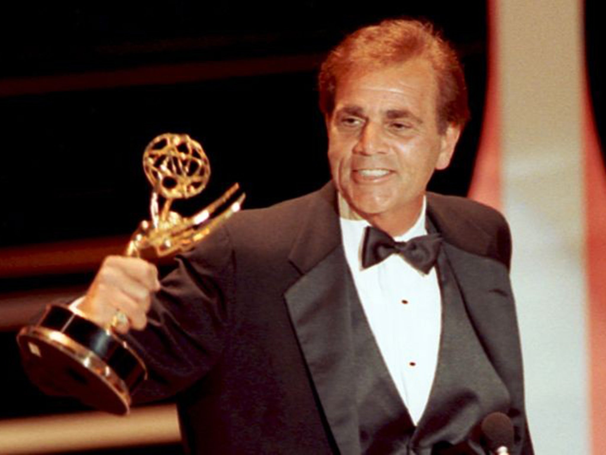 Actor Alex Rocco holds up his Emmy award for best supporting actor in a television comedy series for his role in The Famous Teddy Z in 1990