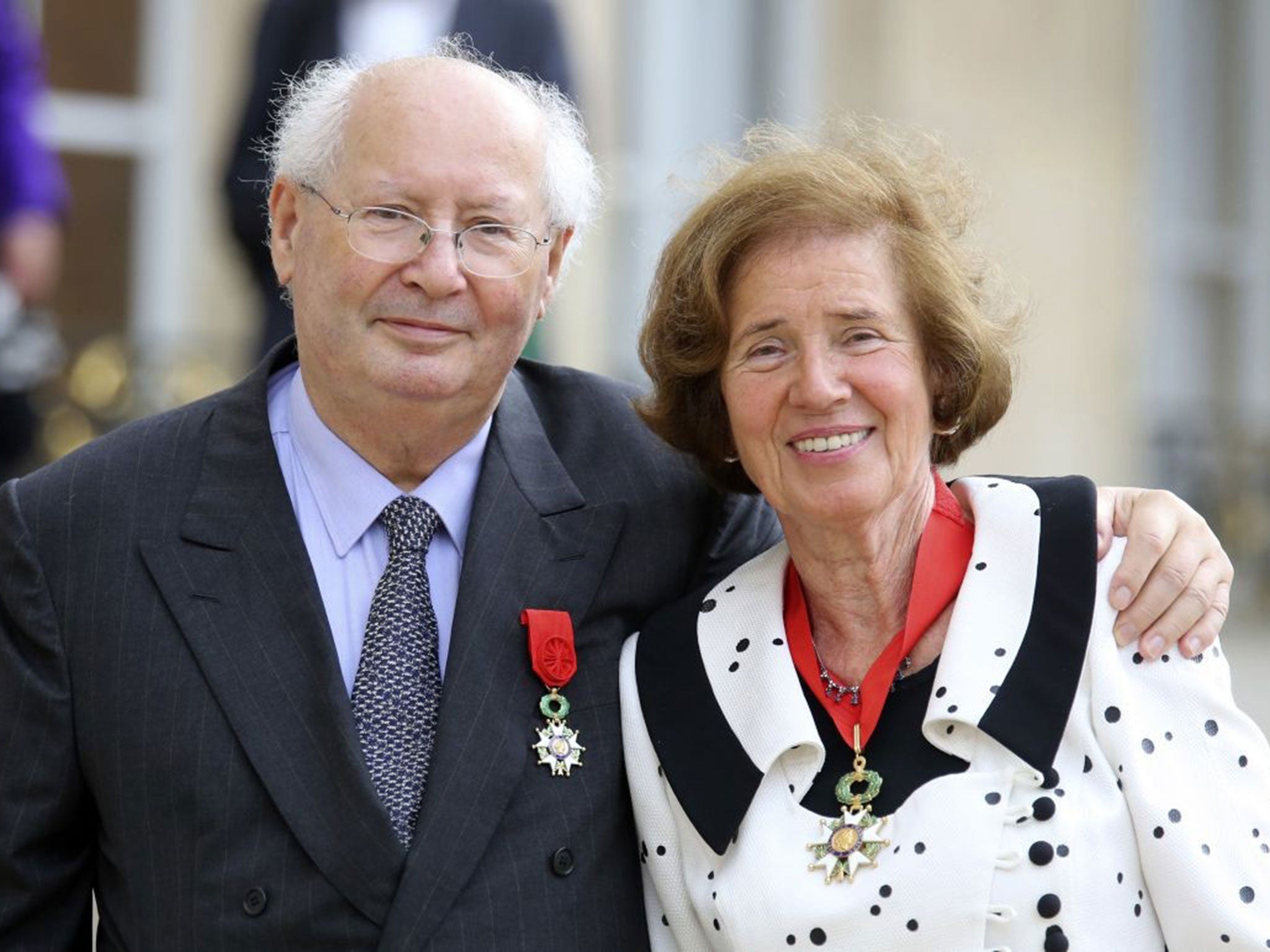 French famed Nazi hunter Serge Klarsfeld poses with his wife Beate, as they leave the Elysee Palace in Paris, after being awarded with the Legion of Honor medal by French President Francois Hollande.