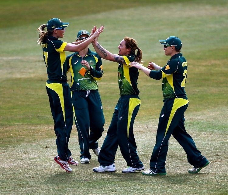 Australia's Sarah Coyte celebrates with Meghann Lanning after taking the wicket of England's Heather Knight