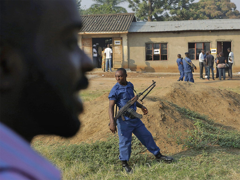 Police officers guard a polling station in Bujumbura