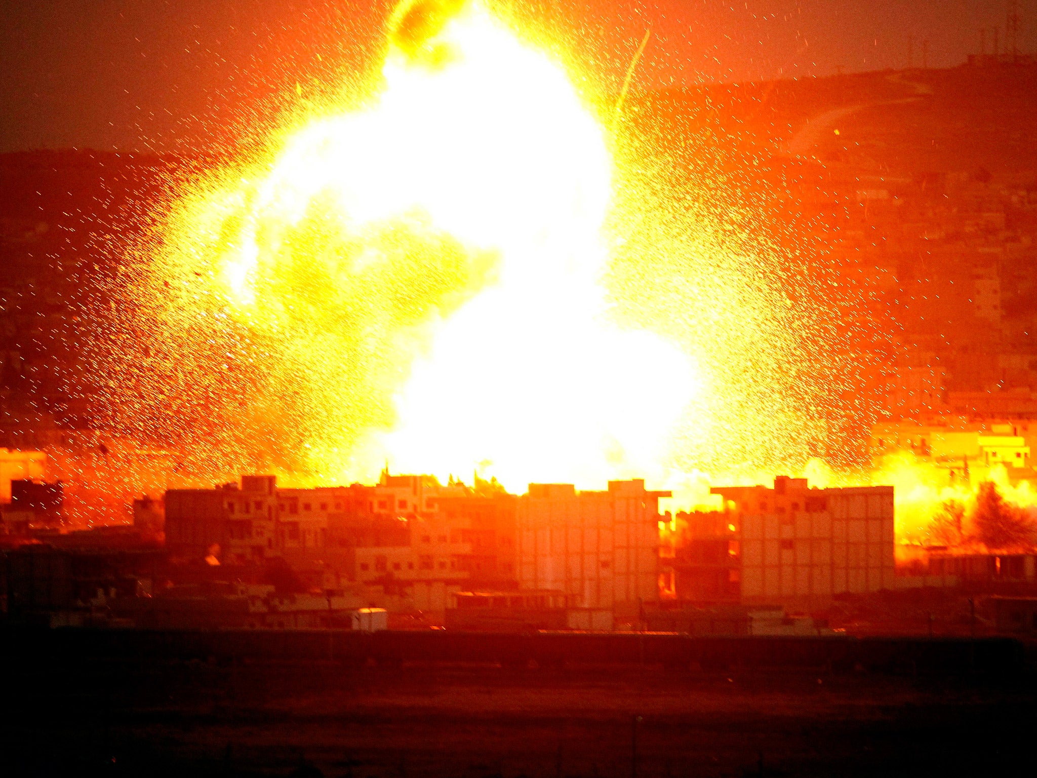 An explosion rocks the Syrian city of Kobani during an airstrike by the US-led coalition last year (Getty)